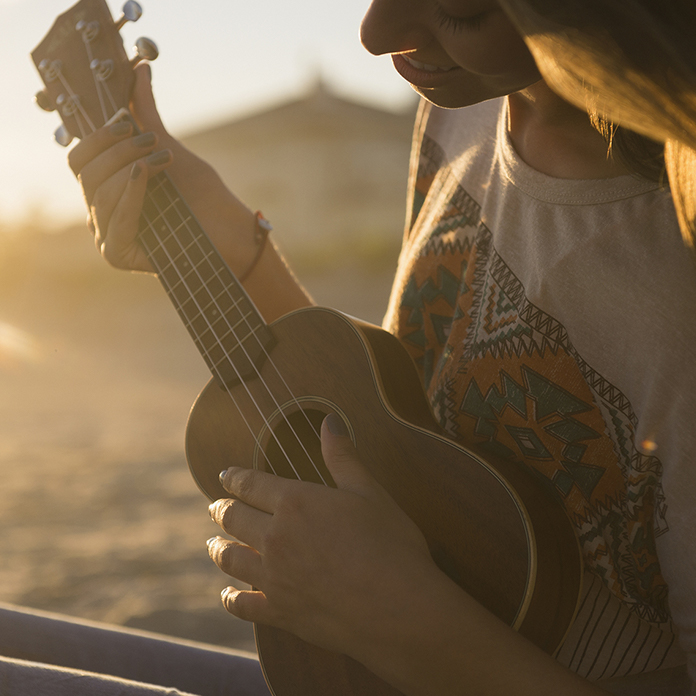 person playing a ukulele