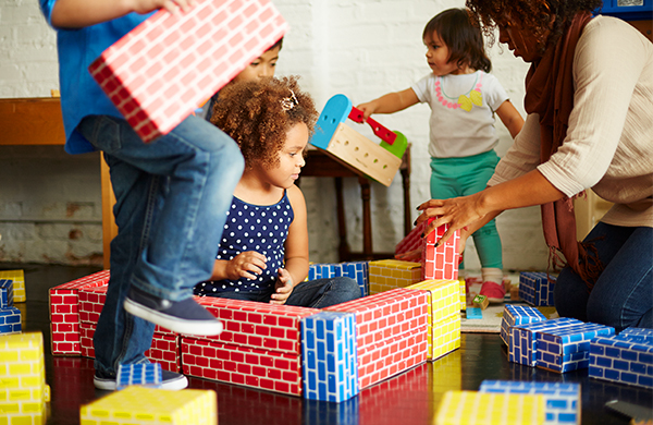 Groupo of toddlers playing with blocks in daycare