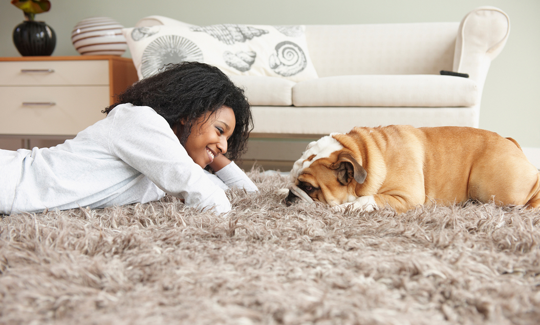 woman and pooch on the carpet