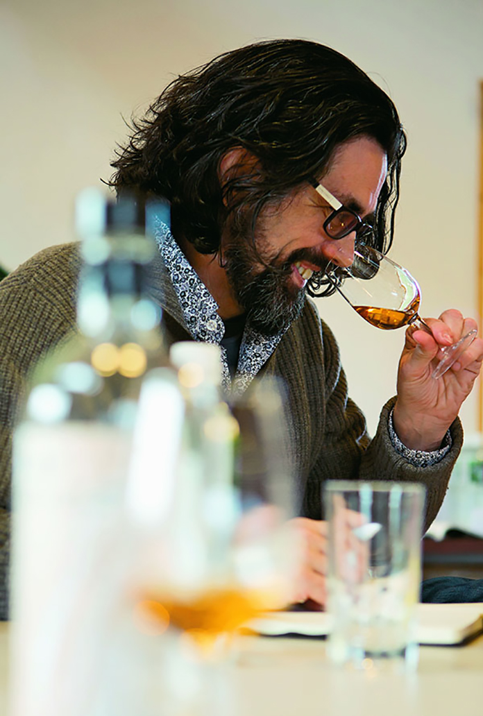 man sniffing whiskey