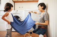 mom and daughter folding laundry