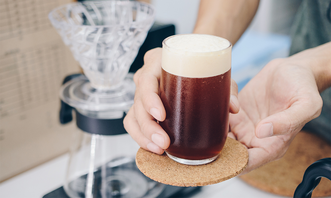 Barista-holding-cold-brew-coffee