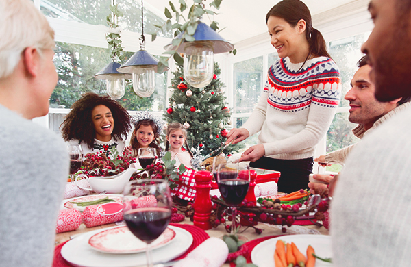 family and friends eating dinner during the holidays at christmas 1 jpg