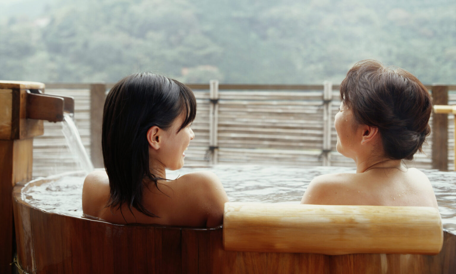 Mother and daughter sitting in hot tub