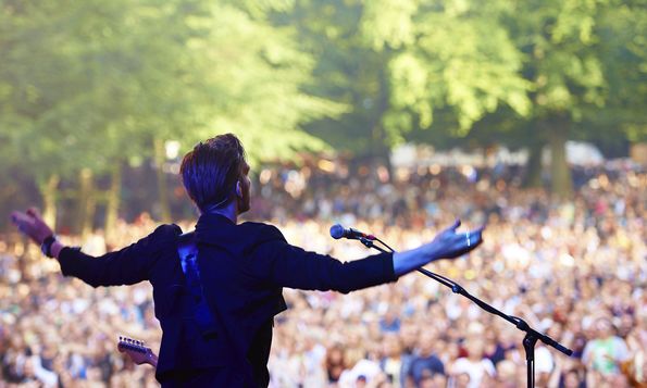 man performing a concert to a crowd
