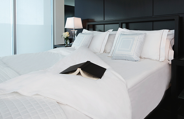 White comforter and bedding in luxurious bedroom