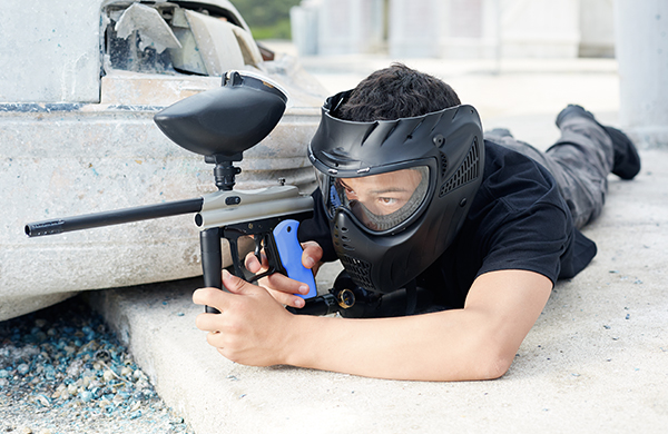 young man playing paintball jpg