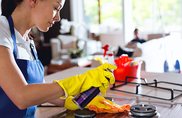 woman-providing-house-cleaning-service-by-cleaning-kitchen