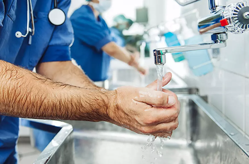 Surgeon washing hands before surgery