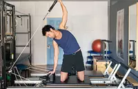 man using Pilates Reformer