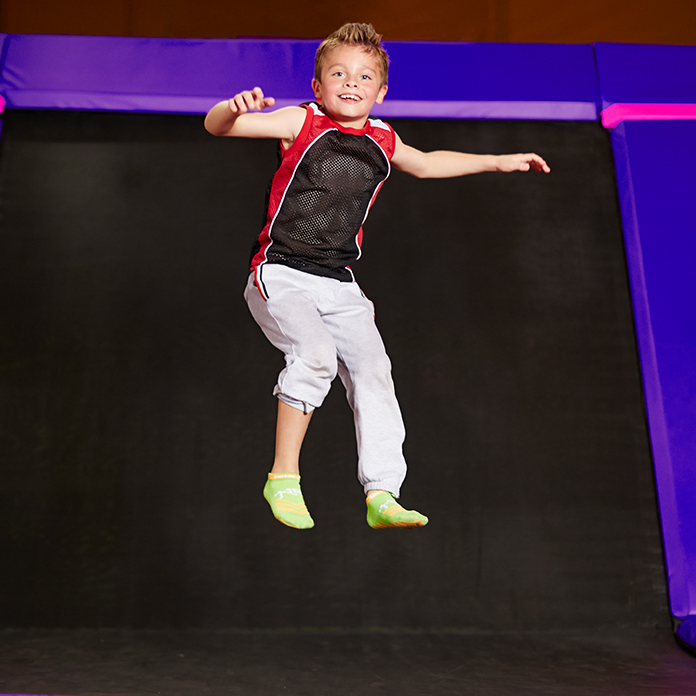 Kid bouncing at trampoline park 