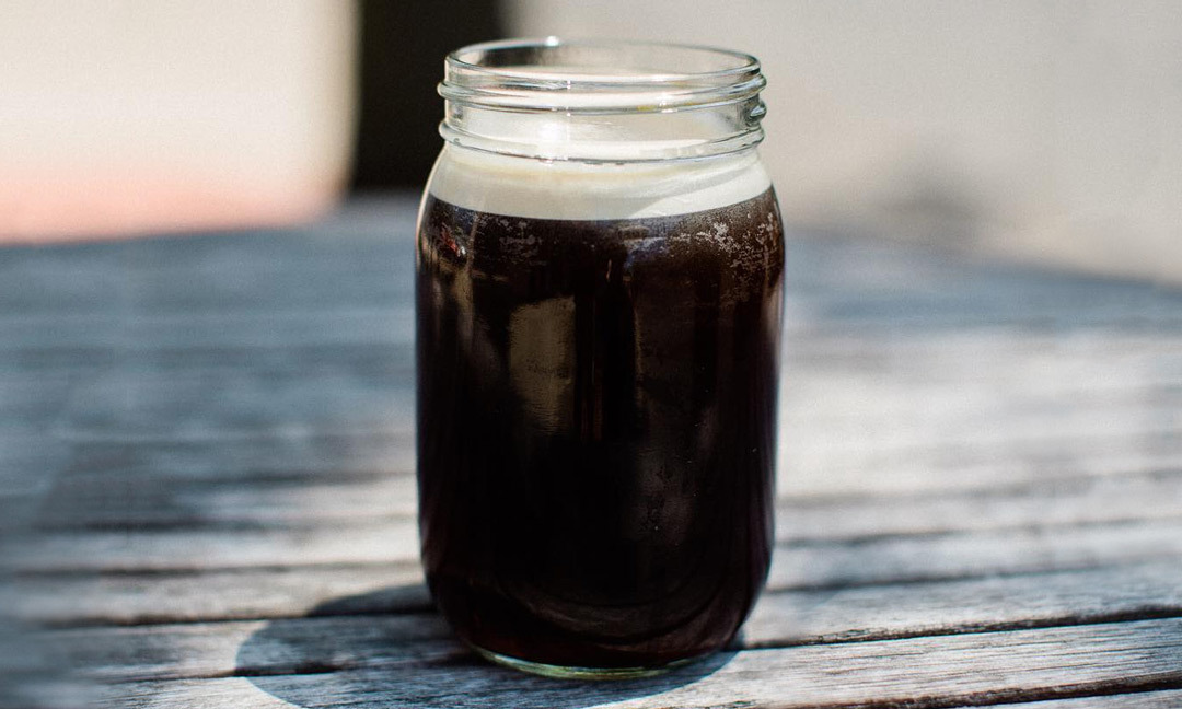 nitro coffee in a mason jar mug