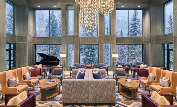 Elegant lobby with piano and chandelier at Hotel Talisa