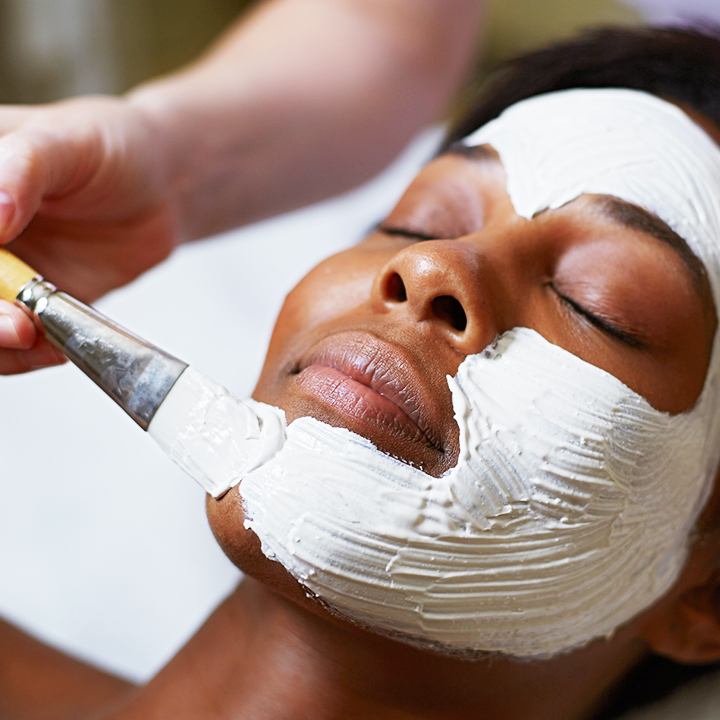 Woman getting a spa facial mask.