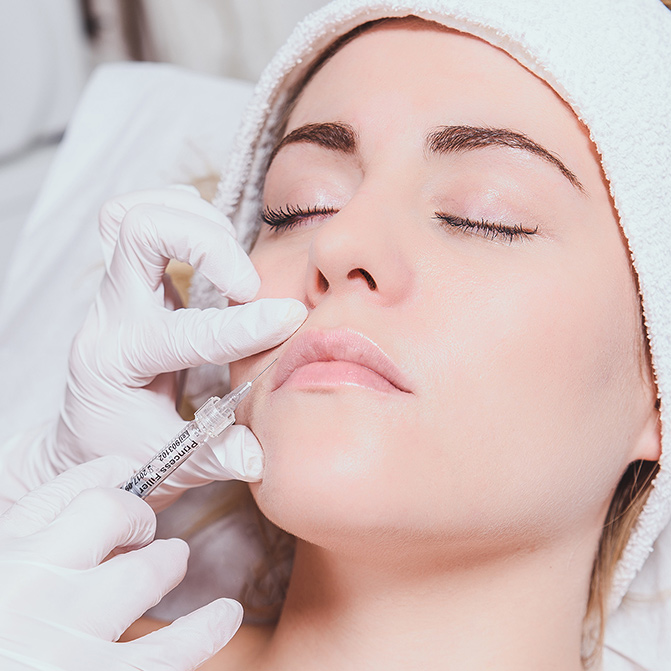Woman getting filler injected near her mouth 