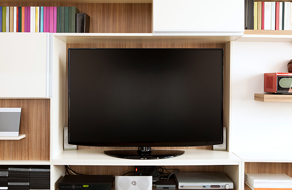 flat screen television mounted in media center cabinet with dvds and media players