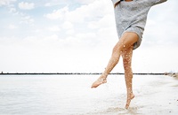 woman in short shorts kicking water