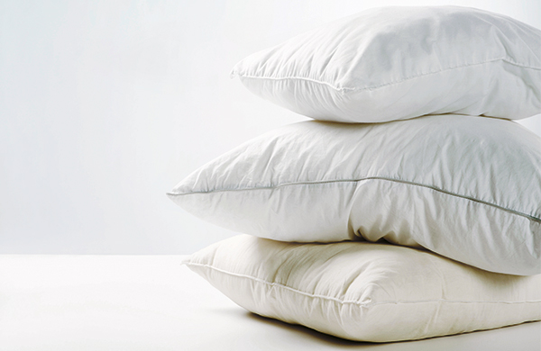 Pile of pillows on a bed