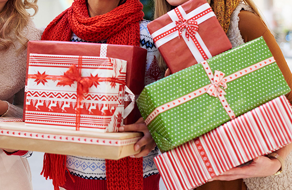 Women balancing a lot of black friday purchases