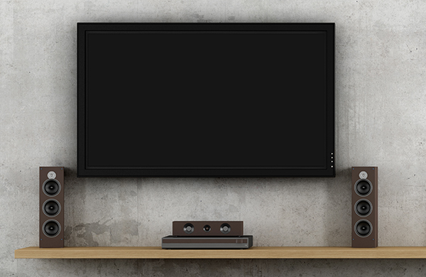 wall-mounted flat screen television with home sound system speakers