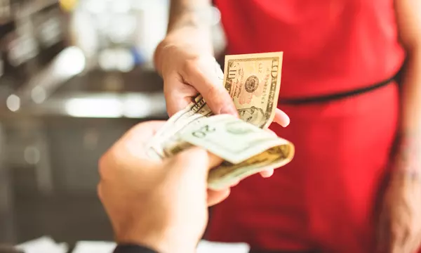 woman tipping for service