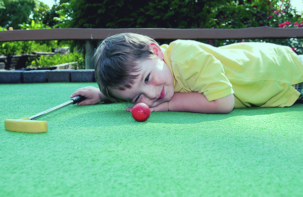 Toddler Playing Mini Golf