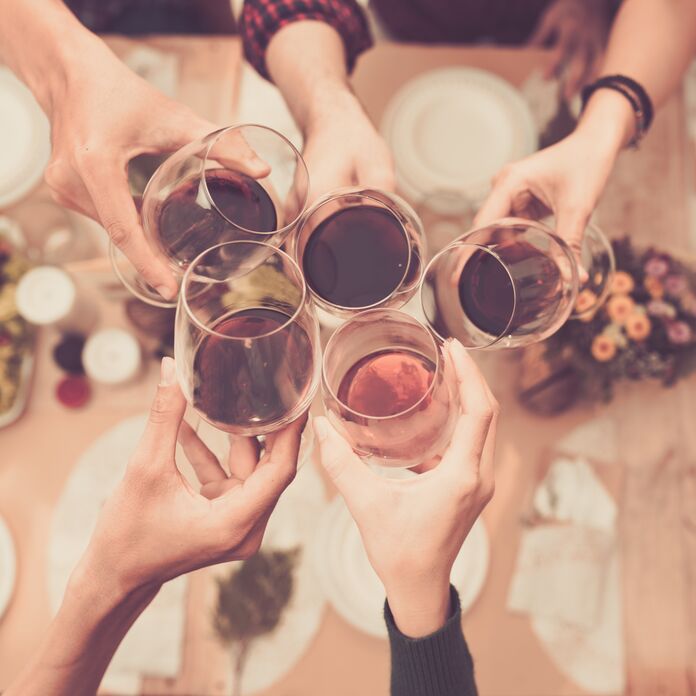 Friends cheersing with glasses of wine