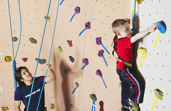 Child rock climbing indoors