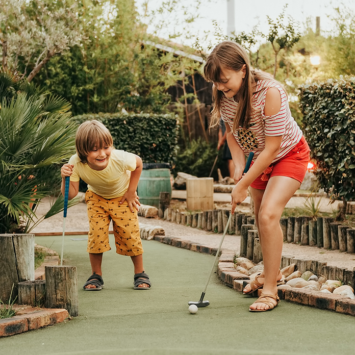 Kid playing mini golf