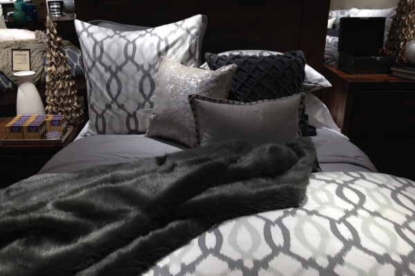 Bed display with a grey colour palette in West Elm