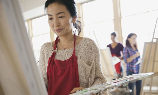 woman painting at a BYOB paiting class