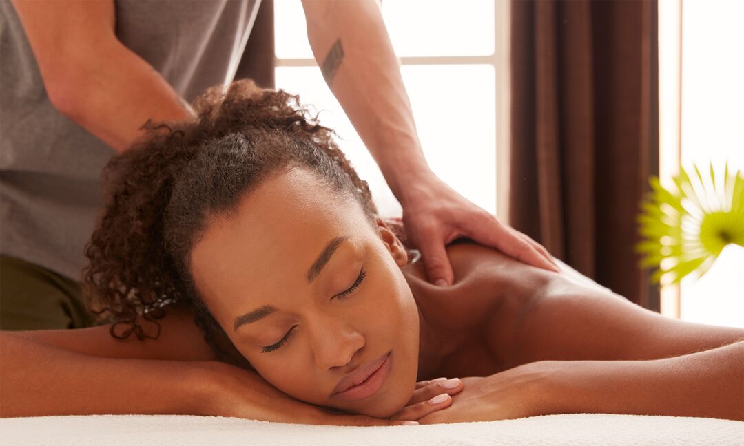 black woman getting a massage at a spa