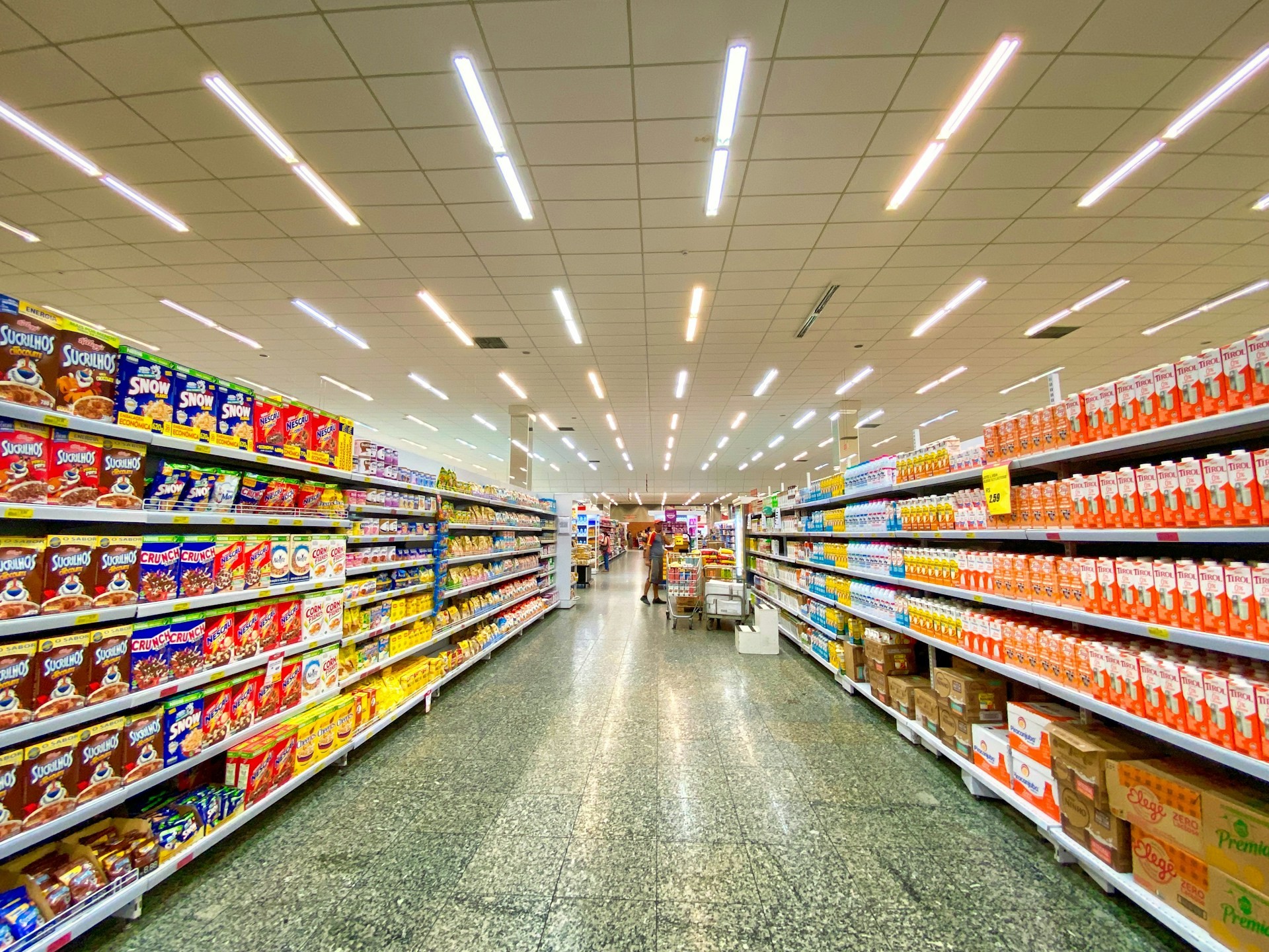 Grocery store aisle with shelves stocked with products