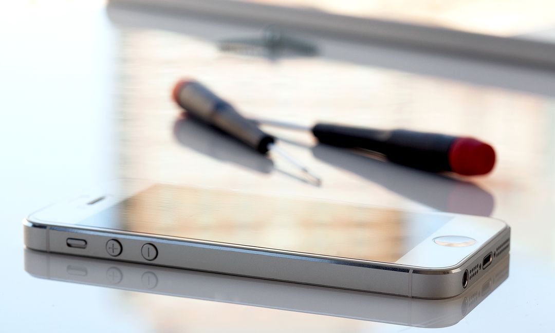 mobile phone on table with tools
