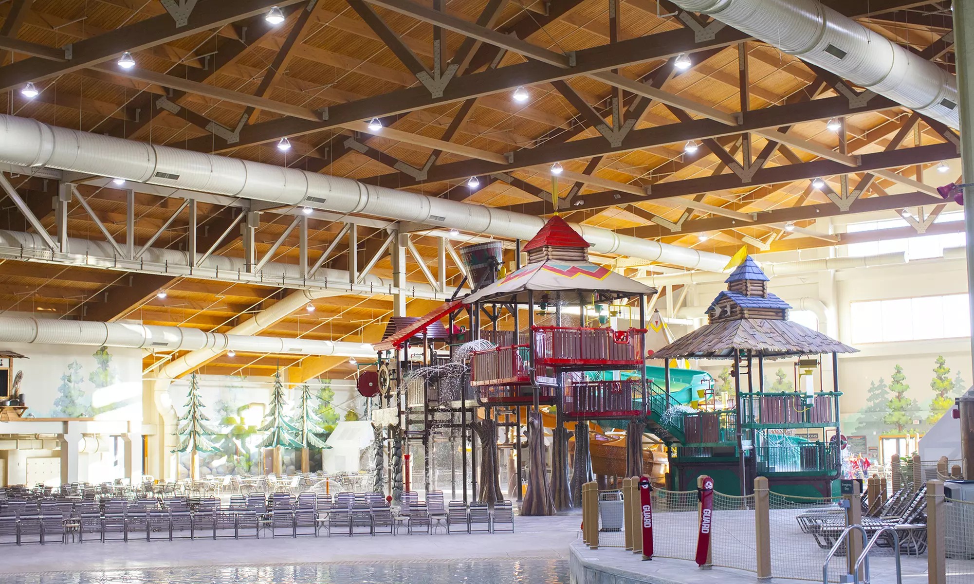 Great Wolf Lodge indoor water park with families enjoying water slides, pools, and splash areas