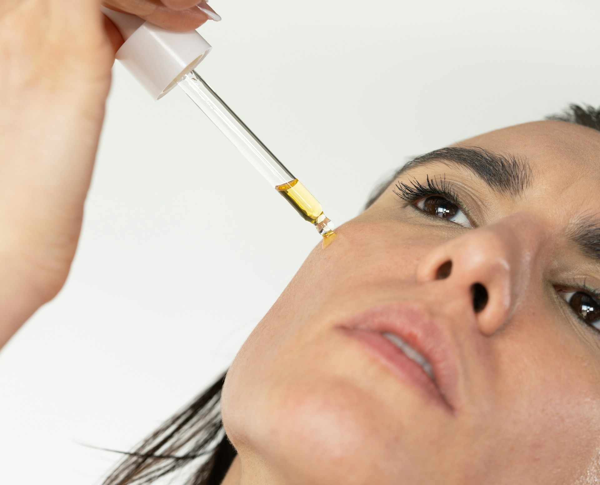 Woman receiving a cosmetic injectable treatment with a fine-gauge syringe