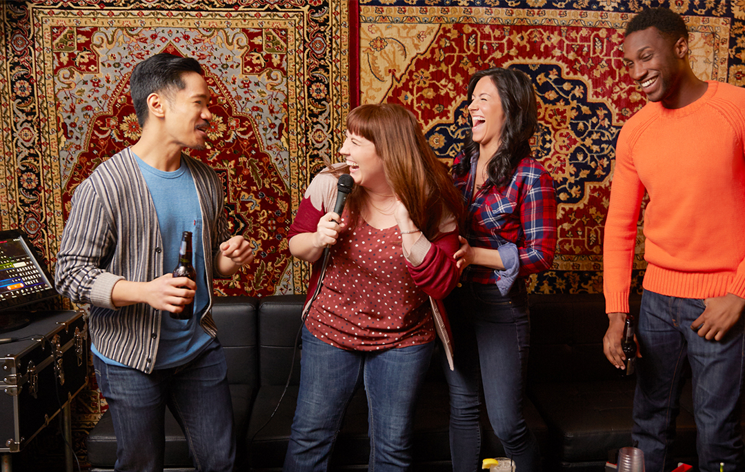 Friends singing karaoke together