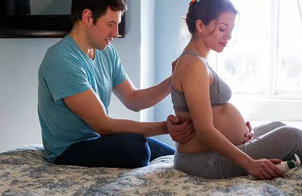 Pregnant woman relaxing at home as part of her prenatal self-care routine