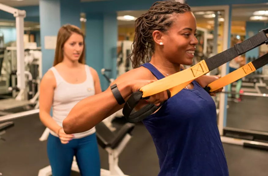 A women does suspension training at Women's Fitness of Boston