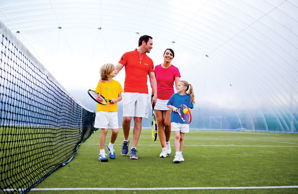 Family on a tennis court at David Lloyd Gym in London