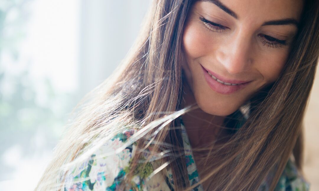 woman with straight hair smiling