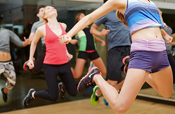 women jumping indoor zumba fitness class jpg