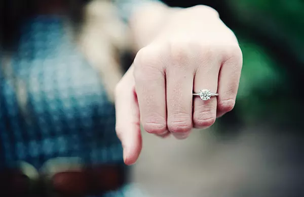 Caucasian woman wearing diamond engagement ring