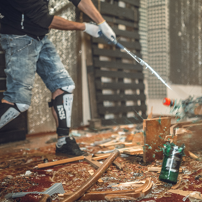 Person breaking stuff in a Smash RX anger room