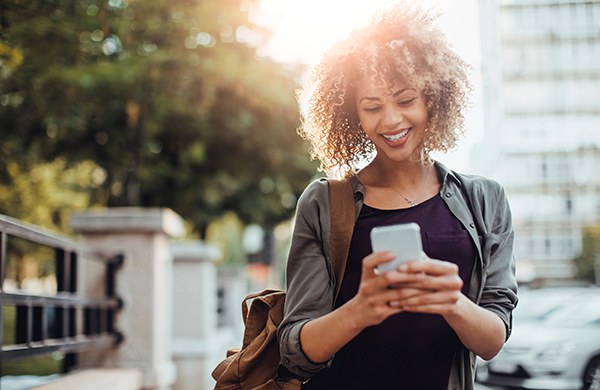 woman using phone on sunny day