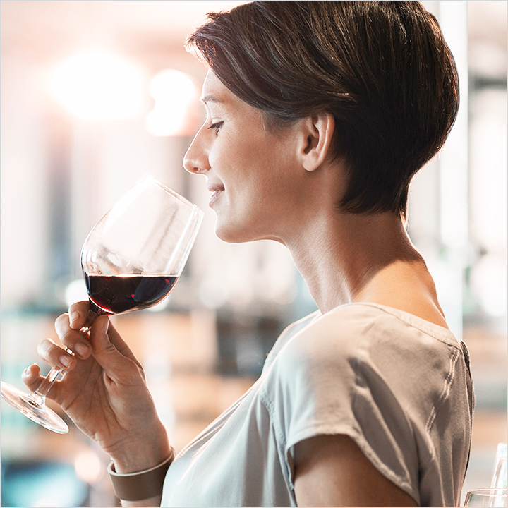 Woman enjoying a wine tasting.