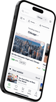 A smartphone showcasing the Groupon app interface highlighting trending activities in Chicago, featuring a 60-minute helicopter flight priced at $288, originally $375, with a 23% discount.